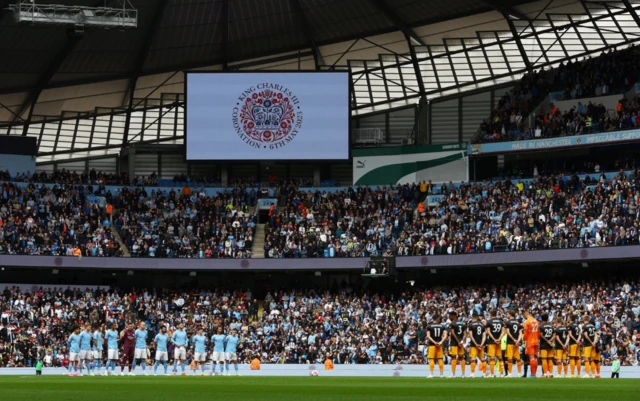 Players stand for the National Anthem before Manchester City vs Leeds