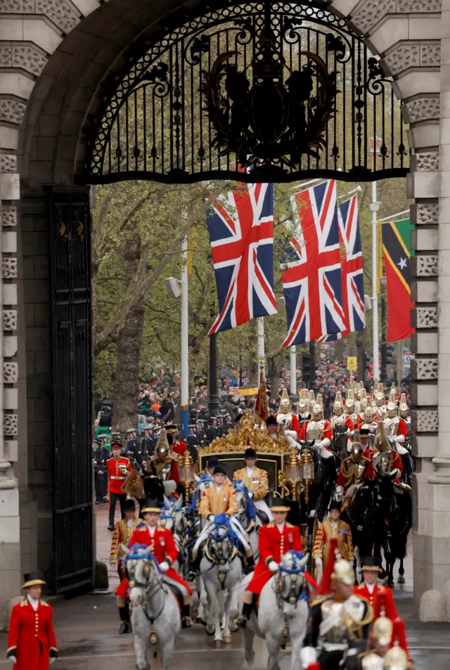 Britain's King Charles and Queen Camilla travel in the Diamond Jubilee State Coach past the Admiralty Arc