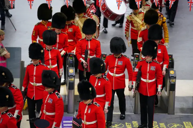 Members of the armed forces taking part in the coronation processions arrive into Waterloo station in London