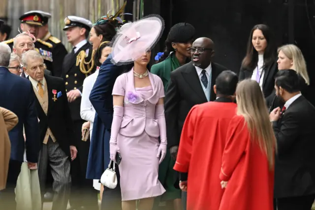 Katy Perry and Edward Enninful arrive at Westminster Abbey ahead of the Coronation of King Charles III and Queen Camilla on 6 May 2023 in London, England