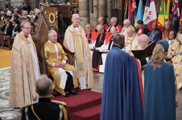 The King sitting in the Coronation chair