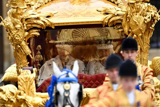 Britain's King Charles and Queen Camilla travel from Westminster Abbey in the Gold State Coach