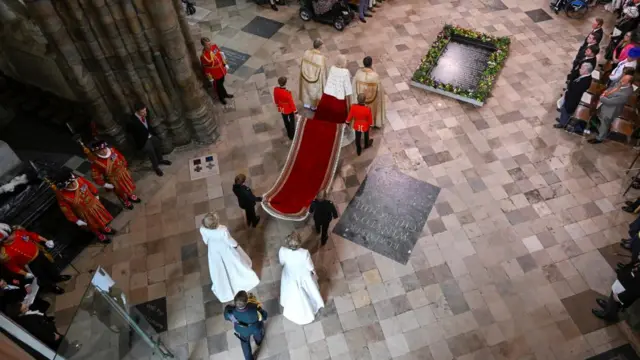 Charles walks up the abbey