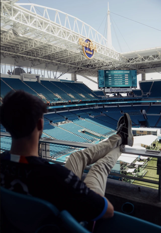 Pierre Gasly puts his feet up in the stands of the Hard Rock Stadium in Miami