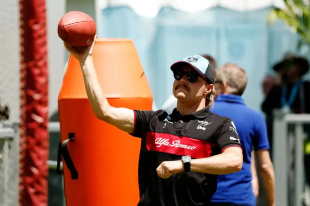 Valtteri Bottas throws an American football