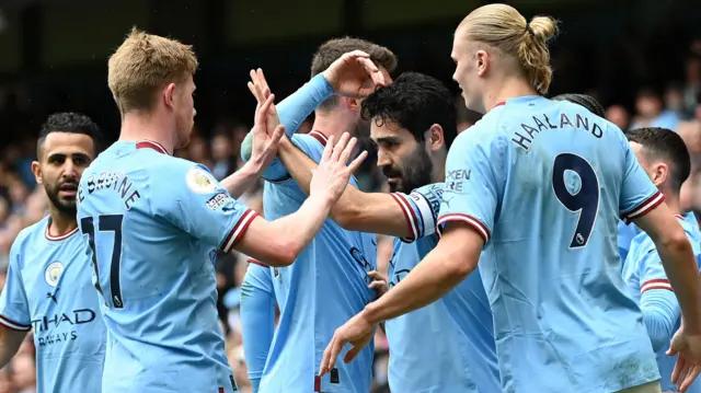 Ilkay Gundogan is congratulated by Manchester City team-mates after scoring against Leeds