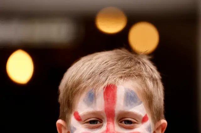 A child has a Union Jack flag painted on his face for a party in St James Church to celebrate Britain's King Charles' coronation, in London, Britain, May 7,