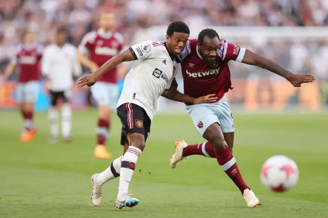 Michail Antonio of West Ham United battles for possession with Tyrell Malacia