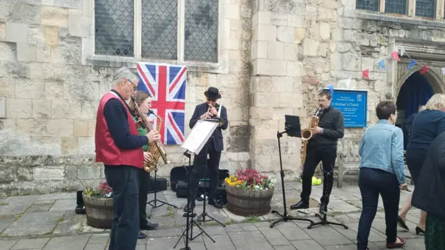 Musicians playing outside St Michael's Church