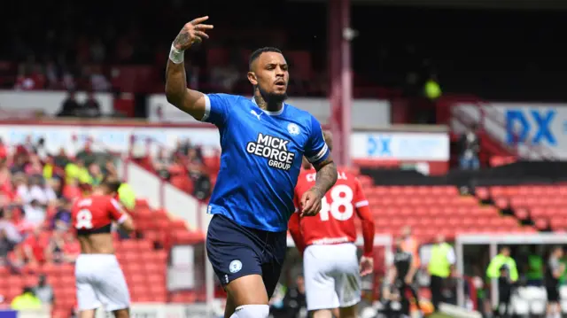 Jonson Clarke-Harris celebrates scoring at Barnsley