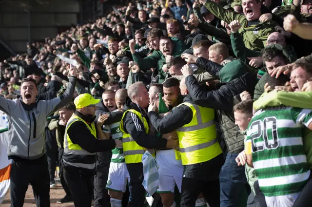 Giorgos Giakoumakis is swarmed by Celtic fans after his late winner in Perth