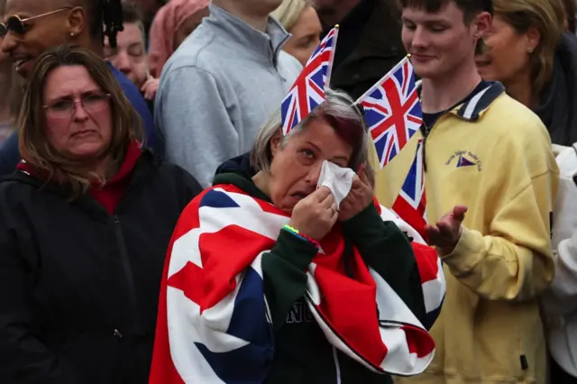 A woman cries during the ceremony