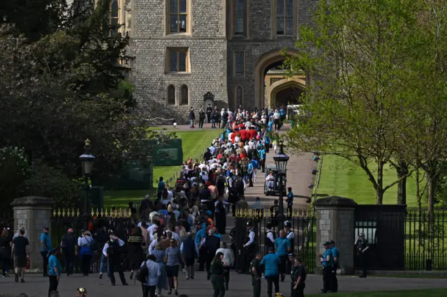 Members of the public queue as they arrive for the Coronation Concert