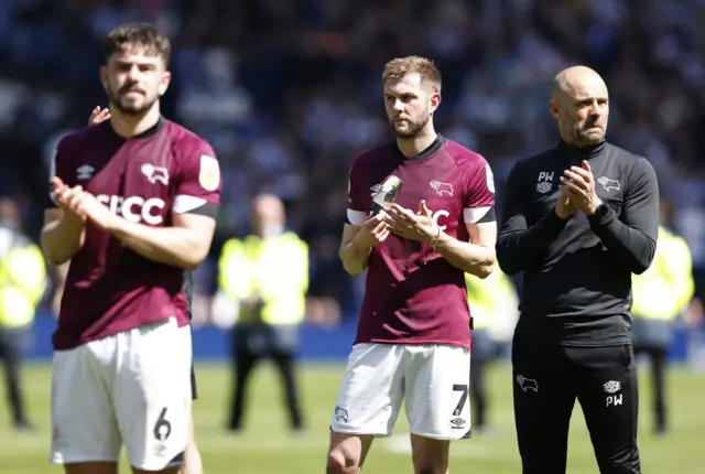 Derby players and manager Paul Warne look dejected