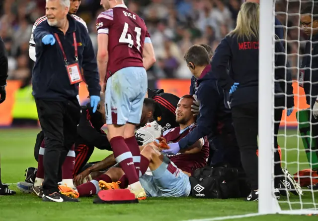 Manchester United's Aaron Wan-Bissaka and West Ham United's Tomas Soucek receives medical attention