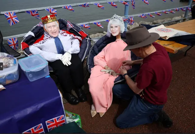 Ralph Pointon adjusts his scarecrows of King and Queen for the Big Lunch on the prom, in Morecambe