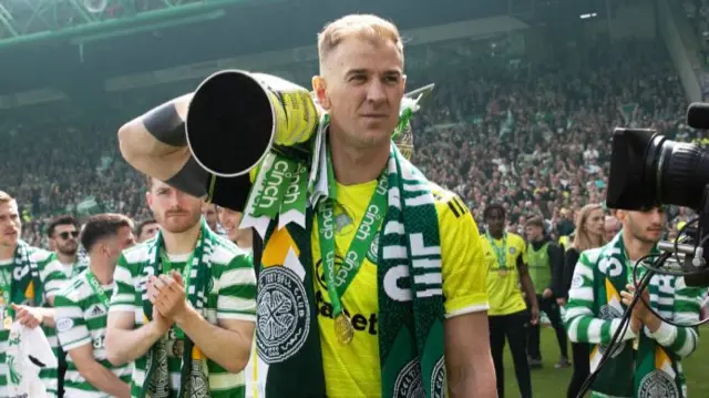 Joe Hart celebrates with last season's trophy