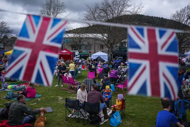 People are seen attending a 'Coronation Big Lunch' in Ballater, Aberdeenshire