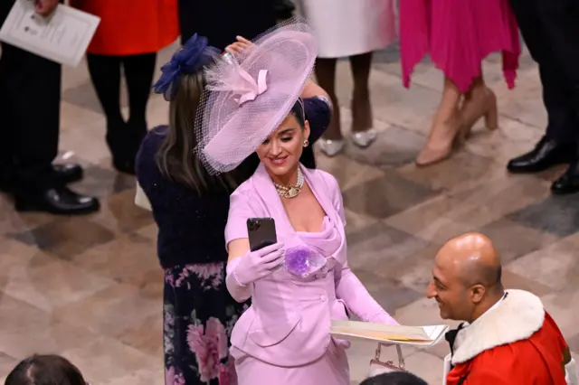 Katy Perry takes selfies during the Coronation of King Charles III and Queen Camilla