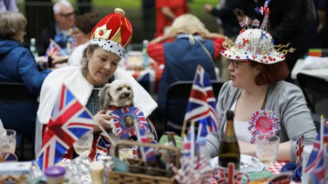 A dog joins the street party in London's Regents Park