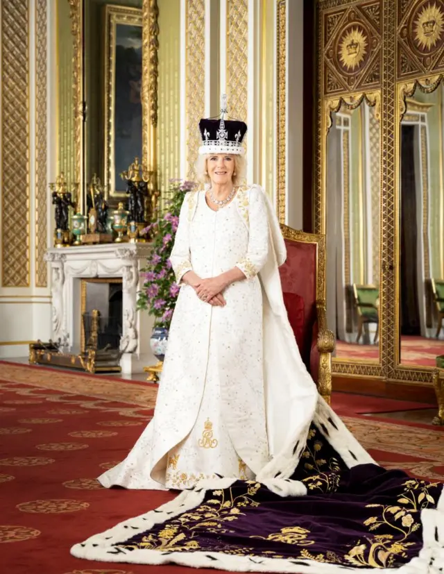 Queen Camilla is pictured in The Green Drawing Room of Buckingham Palace, London. The Queen is wearing Queen Mary's Crown and Robe of Estate.