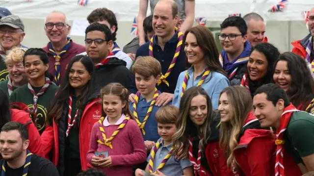 The Prince and Princess of Wales with their three children and volunteers in Slough