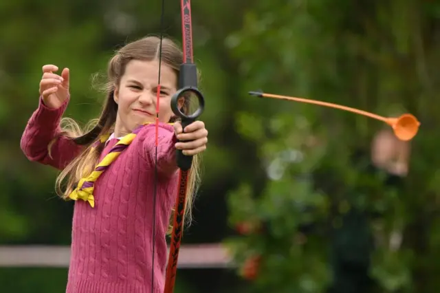 Princess Charlotte takes her turn at archery