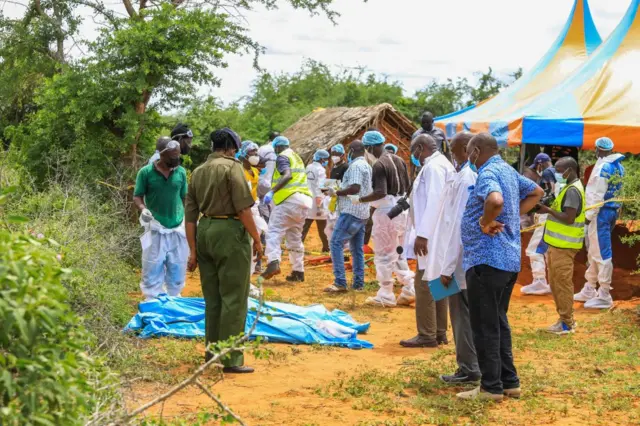 Officials inspect a forested where 90 bodies were found near the Good News International Church in Malindi town of Kilifi, Kenya on April 23, 2023