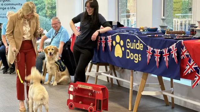 Duchess of Edinburgh gives a dog a treat in Reading