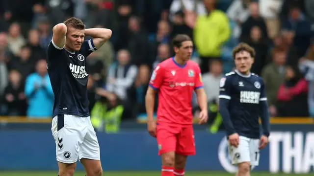 Millwall captain Shaun Hutchinson with his hands on his head