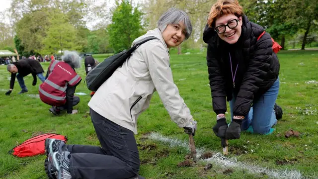 Two women help out with planting in Green Park