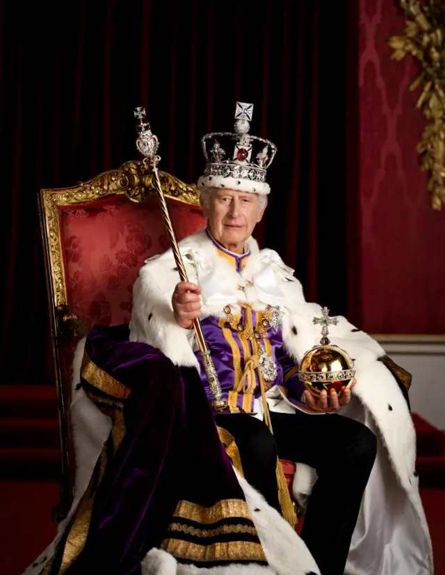 King Charles III is pictured in full regalia in the Throne Room at Buckingham Palace, London.