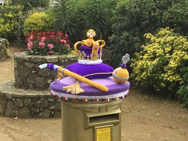 A knitted crown and sceptre tops the only postbox in the Channel Islands