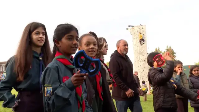 A young girl preparing to throw a dart