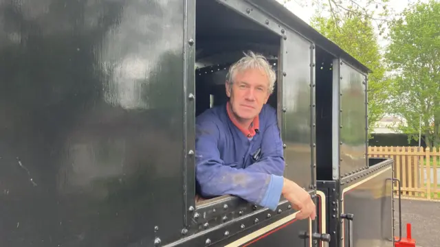 Director of the railway, Peter Mitchell, onboard the Sentinel steam locomotive