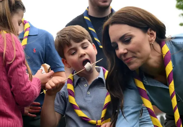 Prince Louis tucks into a marshmallow