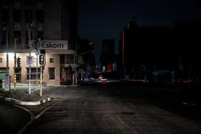 An illuminated signboard on display outside the Eskom Regional Office in Braamfontein, Johannesburg during load-shedding (rolling blackout) on 31 January, 2023