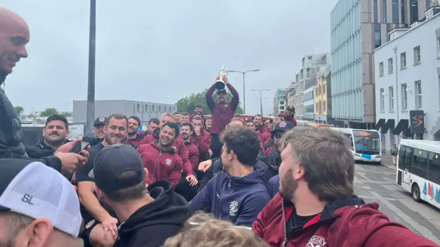 Jersey Reds on top of bus