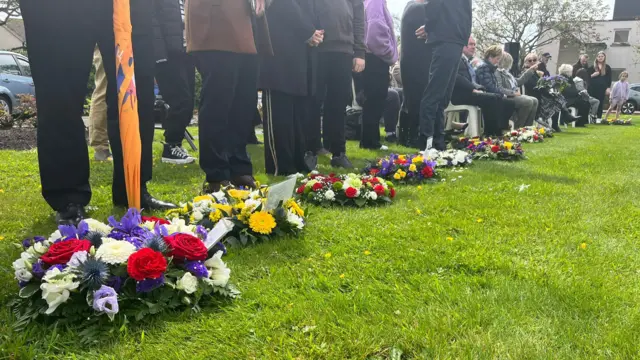 Floral wreaths laid on the grass