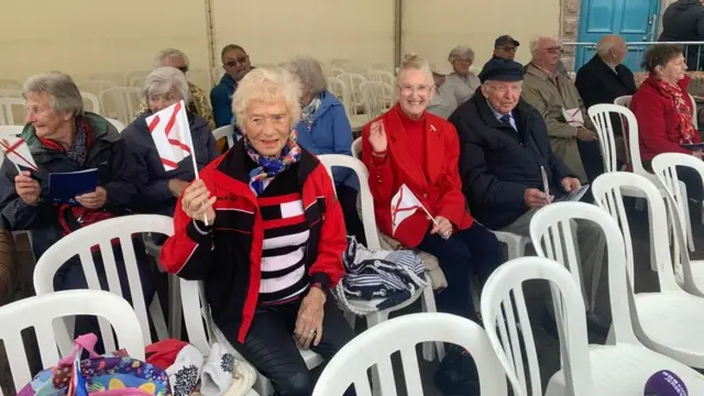 Islanders sitting in a marquee