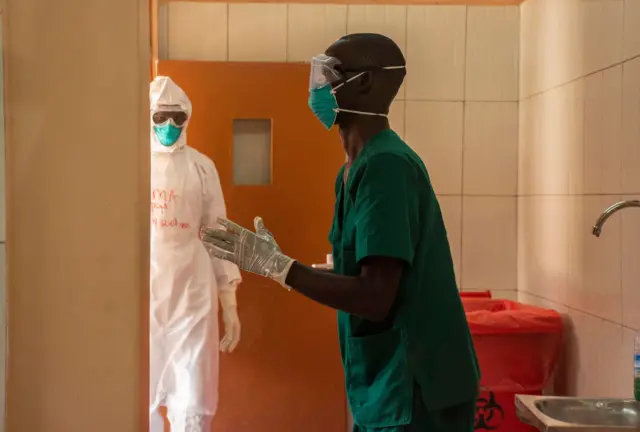 Ugandan doctors dress in their Personal Protective Equipments at the Entebbe Regional Referral Hospital Isolation Centre in Entebbe, Uganda, 20 october 2022.