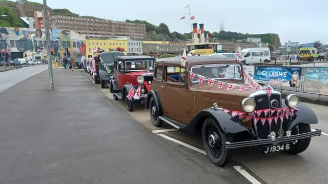 Period vehicles decked in flags