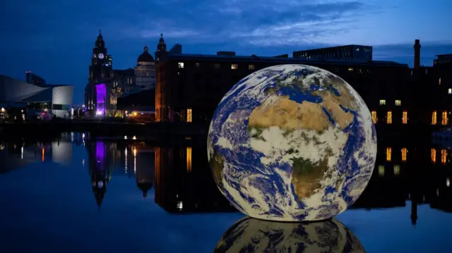 he installation 'Floating Earth' by artist Luke Jerram at the Royal Albert Dock in Liverpool, Britain, 28 April 2023. The 10-metre installation, created using NASA imagery and featuring a soundtrack by composer Dan Jones, is installed in Liverpool's historic Royal Albert Dock to coincide with the arrival of the Eurovision Song Contest ESC in Liverpool.