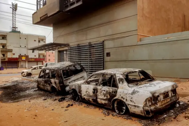 Destroyed vehicles are pictured outside the burnt-down headquarters of Sudan's Central Bureau of Statistics, on al-Sittin (sixty) road in the south of Khartoum on May 29, 2023