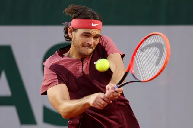 Taylor Fritz hits a backhand shot