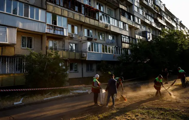 Municipal workers clear debris at the site of a residential building damaged in a Russian missile strike, amid Russia’s attack on Ukraine, in Kyiv, Ukraine June 1, 2023