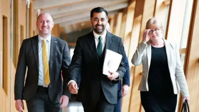 Neil Gray, Humza Yousaf and Shona Robison walk to FMQs