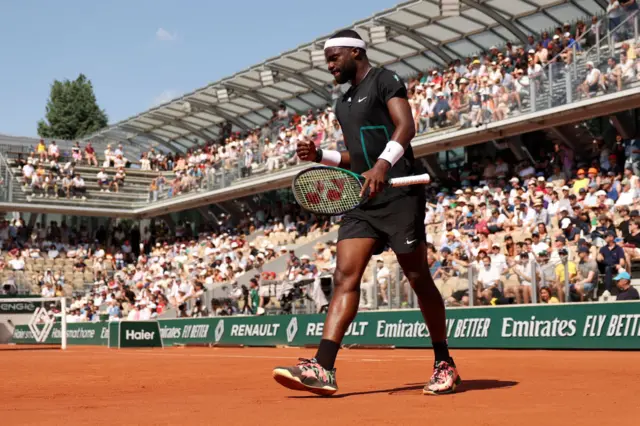 Frances Tiafoe clenches his fist in celebration on Court Simonne-Mathieu