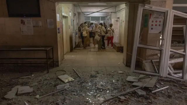 People stand inside a damaged clinic during a Russian missile attack, on June 1, 2023 in Kyiv, Ukraine.