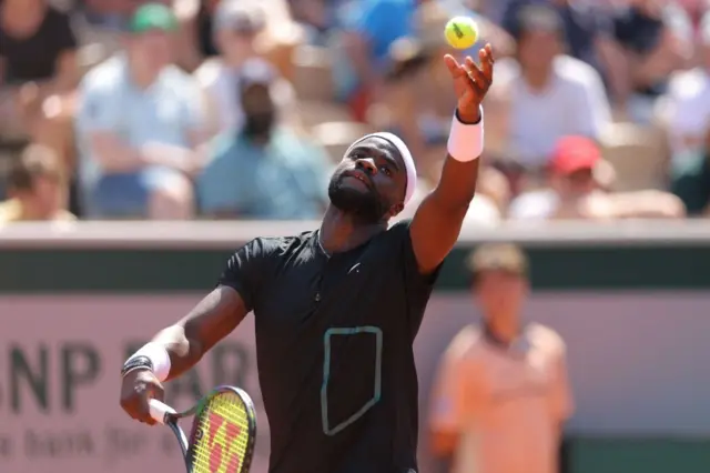 Frances Tiafoe serves